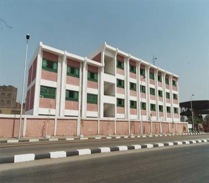 A multistorey building with white and pink facades and green windows.