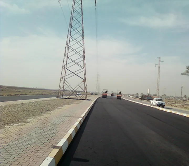 An asphalt road beside block paving and concrete kerbs.